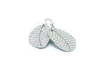 A pair of small leaf earrings in gray by ColorUpLife.